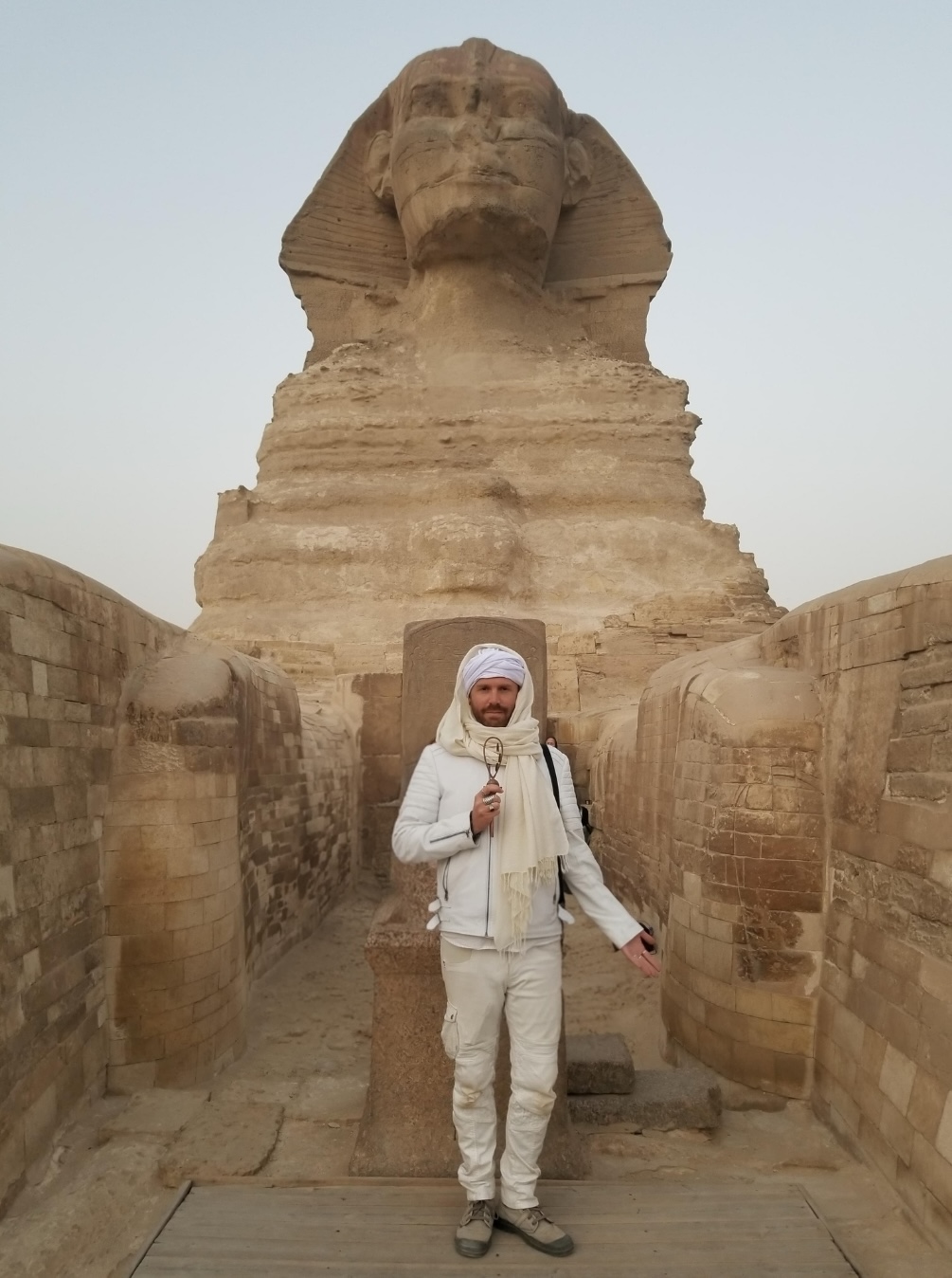 Tala Sage standing between the paws of the Great Sphinx of Giza at dawn